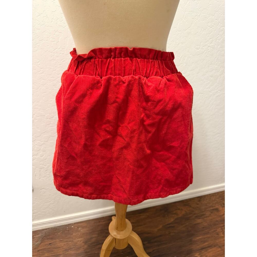 Red corduroy mini skirt with pockets